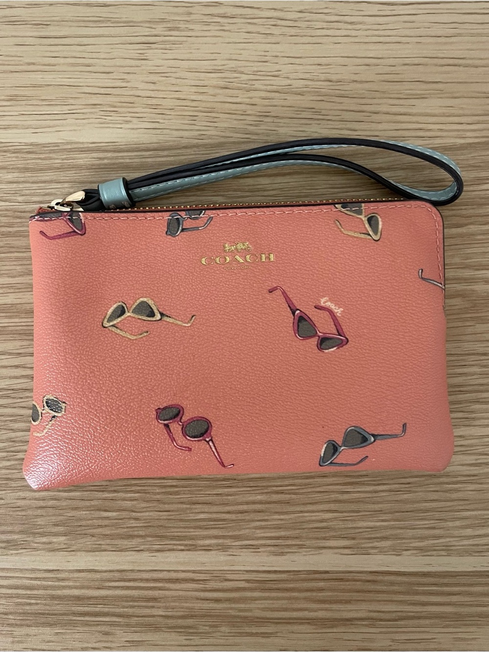 COACH Coral Leather Wristlet with Sunglasses Print